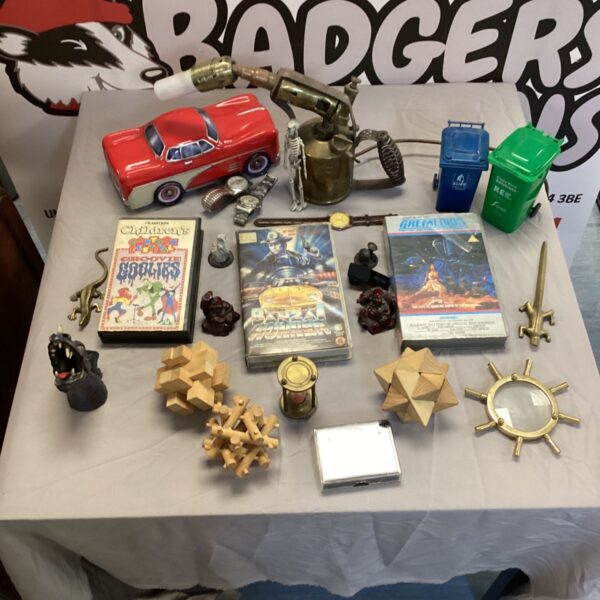 Vintage VHS tapes and brass ornaments lot for collectors.