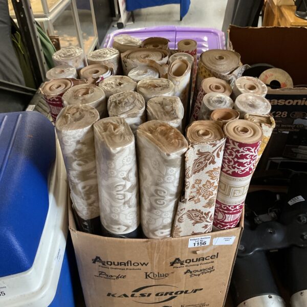 Lot of vintage wallpaper rolls with floral and damask patterns.