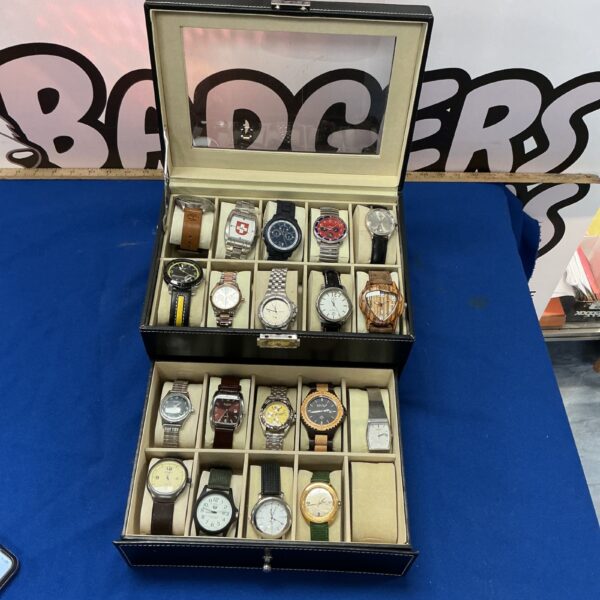 Vintage leather watch display case with assorted timepieces.