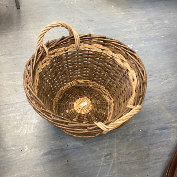 Vintage wicker basket with a woven handle, ideal for farmhouse decor.