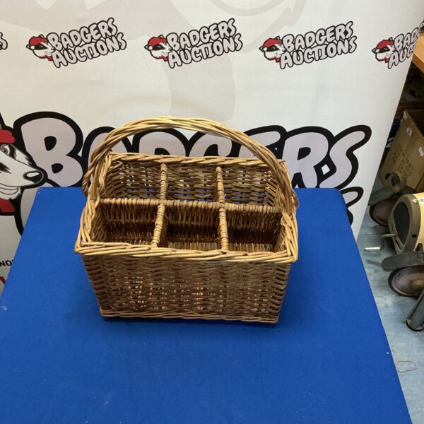 Vintage wicker wine basket with six bottle openings.