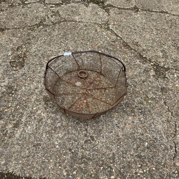 Vintage wire hanging basket for plants or rustic home decor.