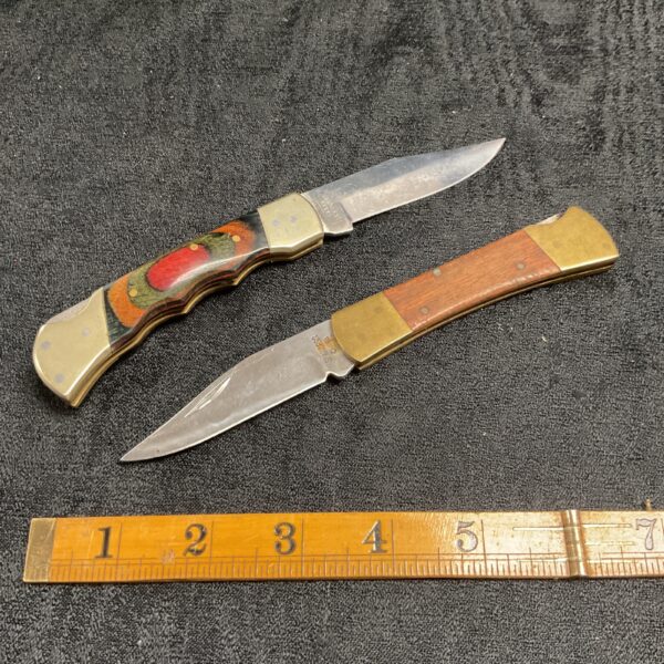 Vintage pocket knives with wood handles and stainless steel blades.