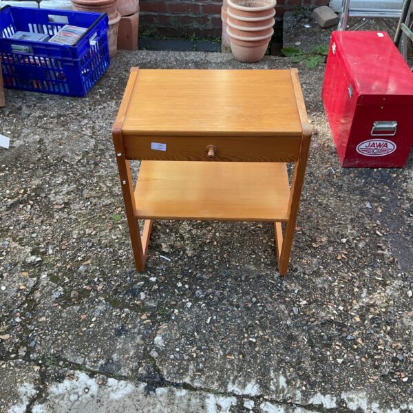 Vintage wooden bedside table with a single drawer and shelf.