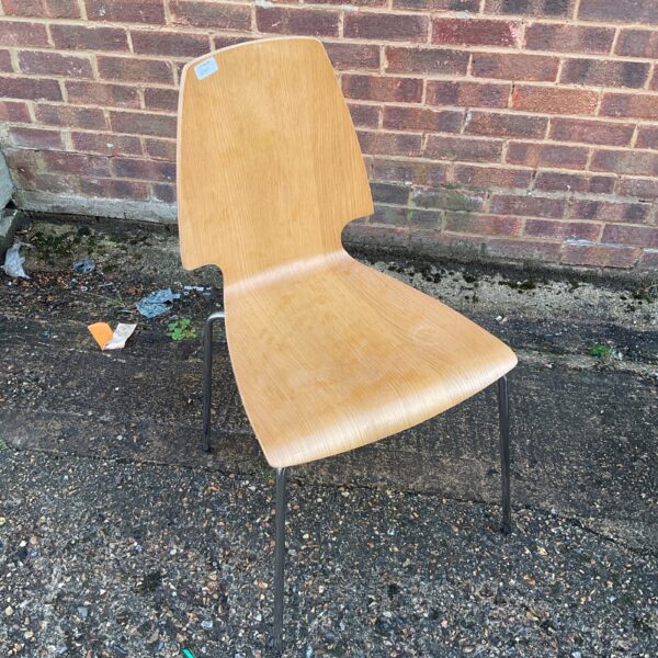 Vintage wooden chair with black legs, mid-century modern style.