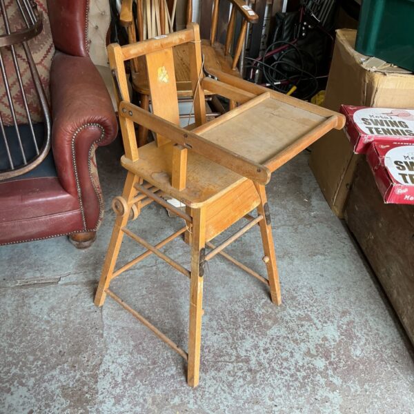 Vintage wooden high chair with a weathered patina.