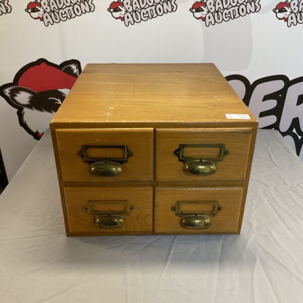 Vintage wooden pigeon hole with four drawers for desk organization.