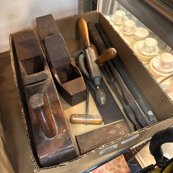 Vintage woodworking tools including hand planes and chisels.