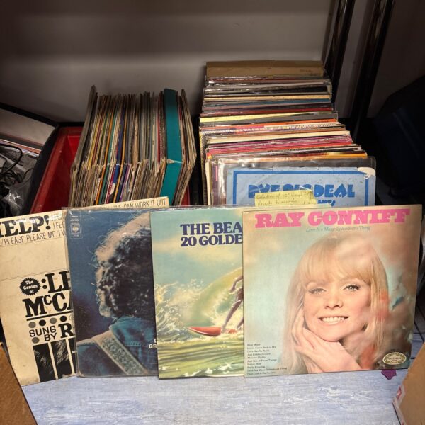 Vintage vinyl LP record collection featuring artists like The Beatles and AC/DC.
