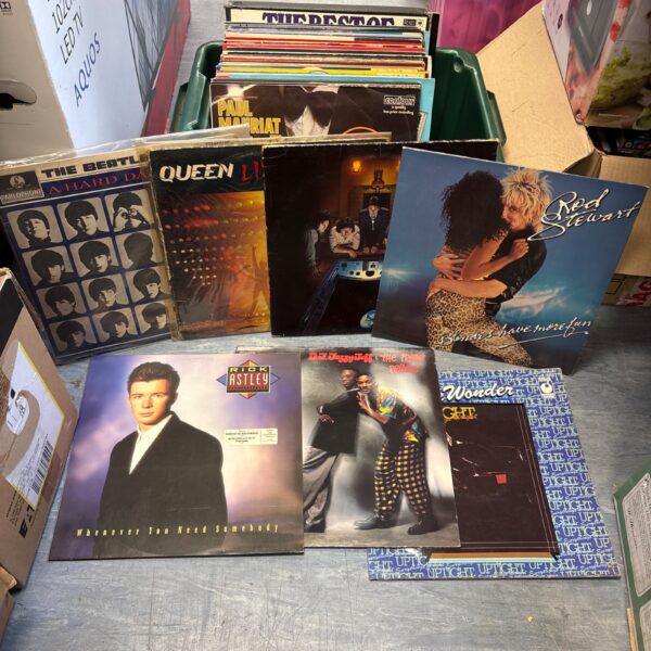 Collection of vintage vinyl LP records by The Beatles, Queen, and Rod Stewart.