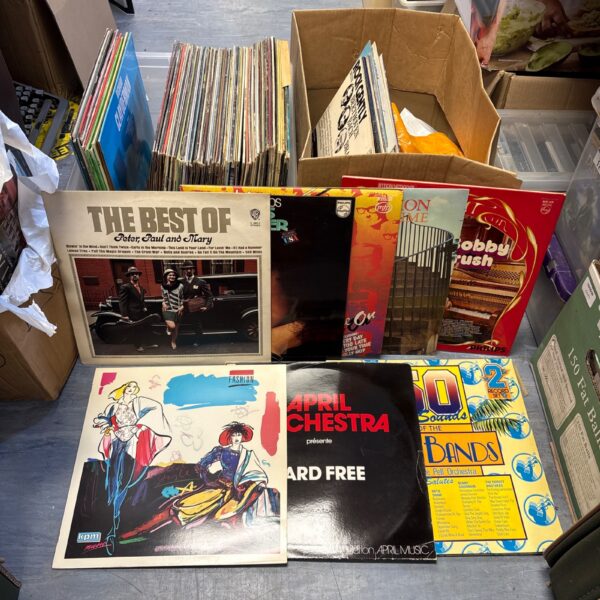 Mixed vinyl record collection with Tom Jones records visible.