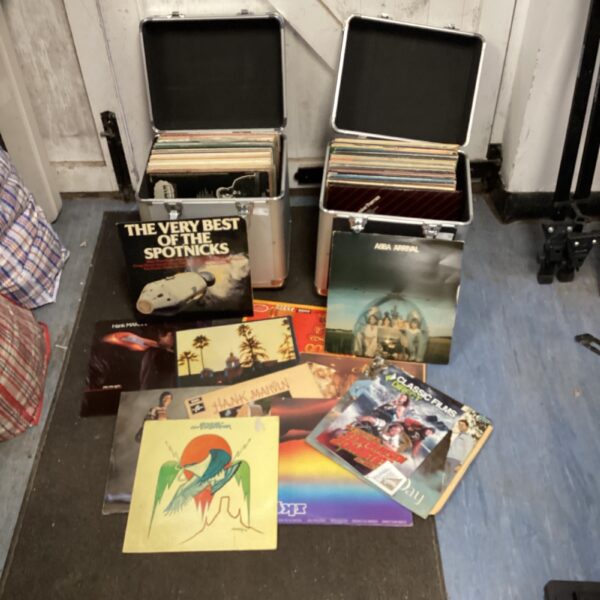 Vintage vinyl records in aluminium flight cases, including ABBA and Hank Marvin.