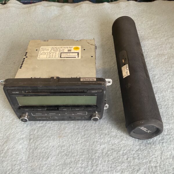 Vintage VW car stereo with Walk Bluetooth speaker in used condition.