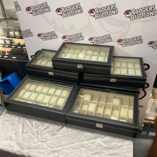 Lot of seven empty watch display cases with three watches.
