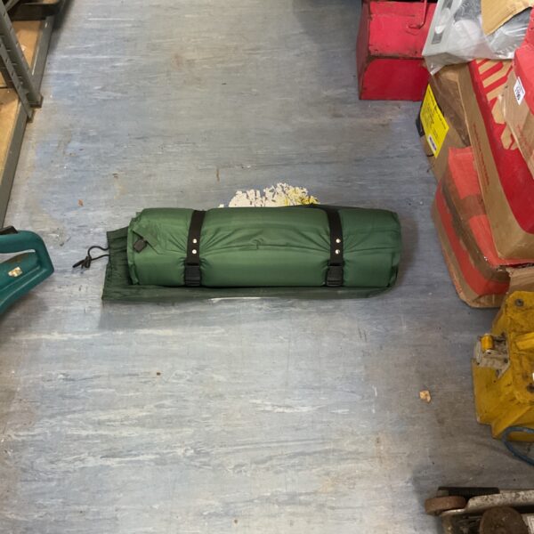 Green Weetwoods self inflating mat rolled up for storage.