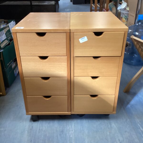 Pair of wooden wheeled cabinets for office storage.