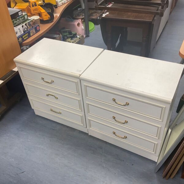 Pair of white bedside tables with single drawers.