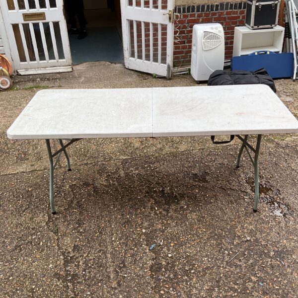 White Hartleys folding table in a garden setting.