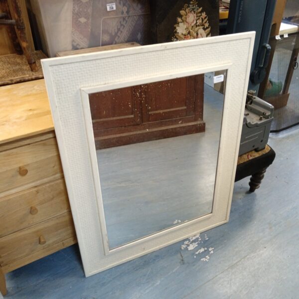 White rectangular framed mirror for home decor.