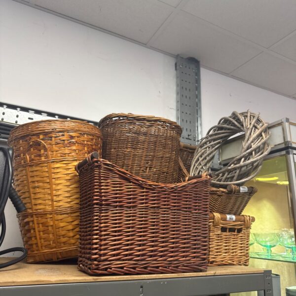 Selection of vintage wicker baskets and a woven wreath for storage.