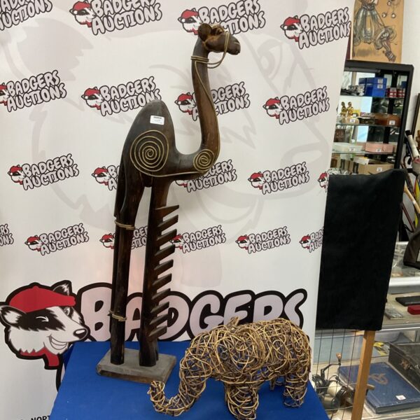 Rustic wooden camel CD rack with wicker elephant.