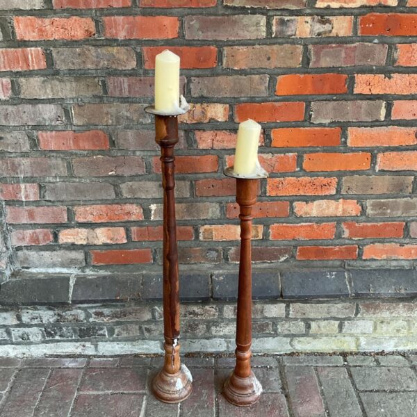 Pair of vintage wooden candlesticks for home decor.