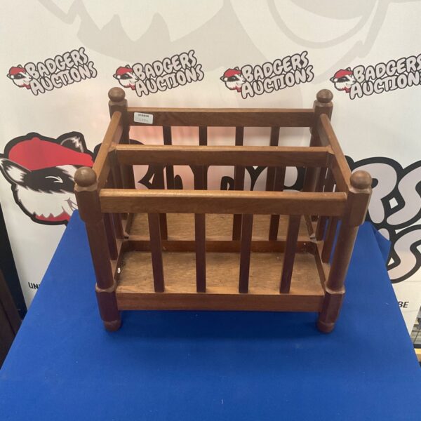 Vintage wooden magazine rack for storing books and magazines.