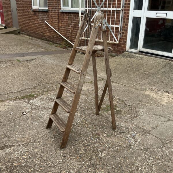 Vintage wooden step ladder with three steps, rustic farmhouse style.