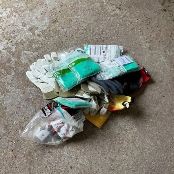 Mixed lot of pre-owned working gloves for various tasks.