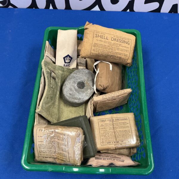 WWII First Aid Kit with shell dressings, vintage military medical supplies.