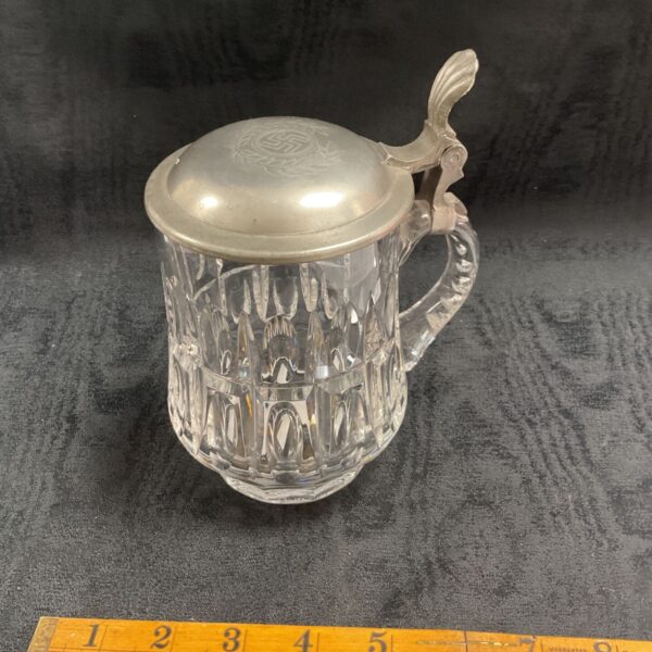 WWII German beer stein with pewter lid, detailed embossing.