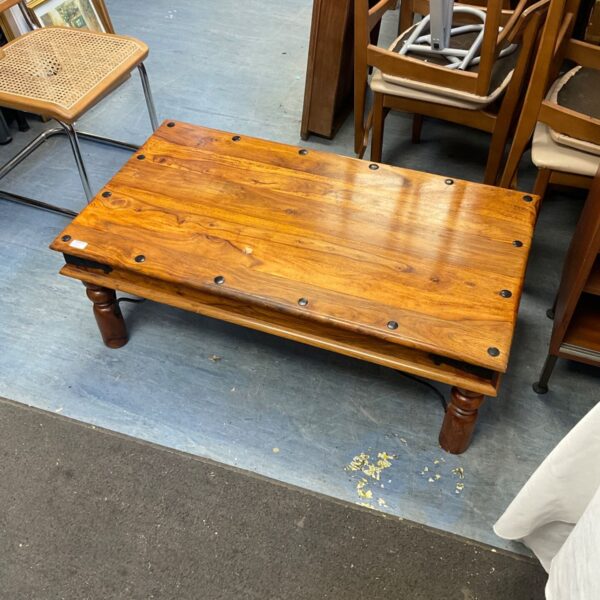 Rustic yak coffee table with iron details and turned legs.
