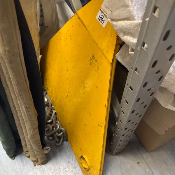 Yellow vehicle wheel clamp for car security.