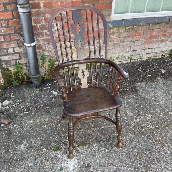 Antique yew wood Windsor chair with carved spindle back.