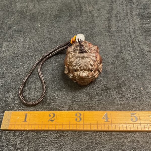 Antique 1919 boxwood netsuke with detailed carving.