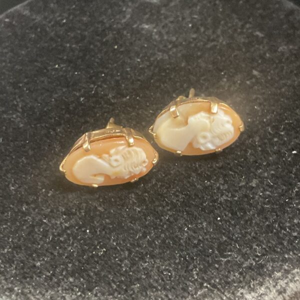 Pair of vintage 9ct gold cameo earrings on a dark surface.