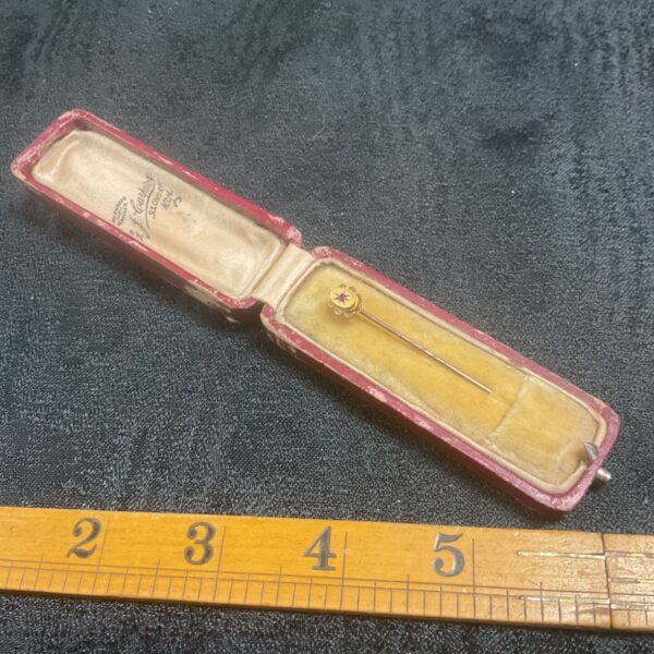 Antique 9ct gold stickpin with a ruby floral design.