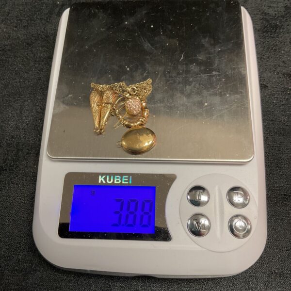 Close-up of 3.89g scrap 9ct gold floral pendant for repurposing.