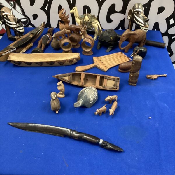 Lot of diverse African carvings including animal figurines and a xylophone.