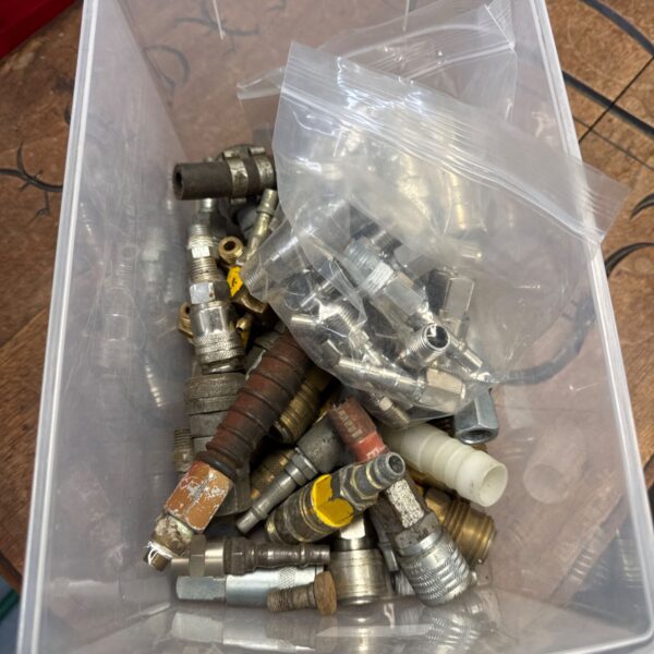 Assorted airline connectors in a plastic container, pneumatic fittings.