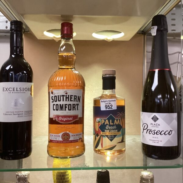 Collection of unopened alcohol bottles including Southern Comfort and Prosecco.