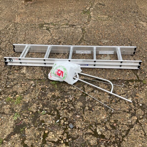 Aluminium extending ladder with rail accessories for DIY projects.