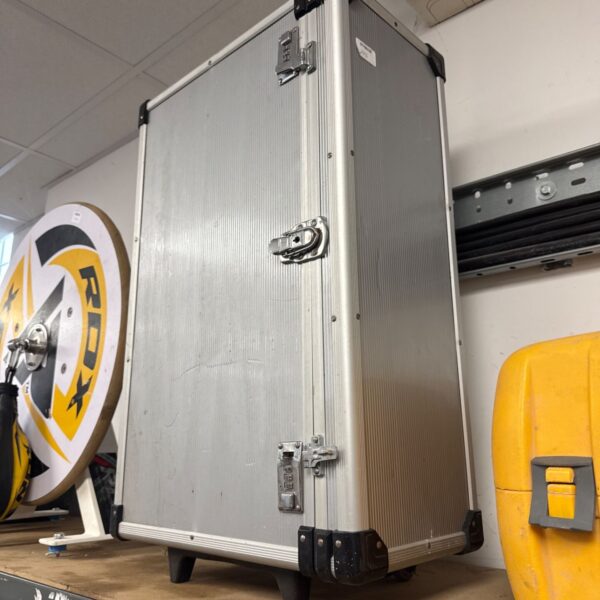 Silver aluminium transit case with wheels and extending handle.