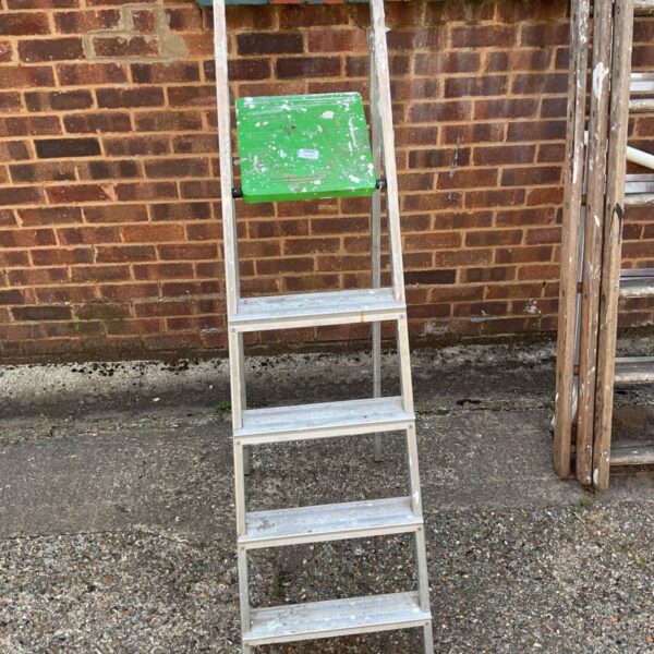 Vintage aluminum step ladder with four steps, ideal for garden or DIY.
