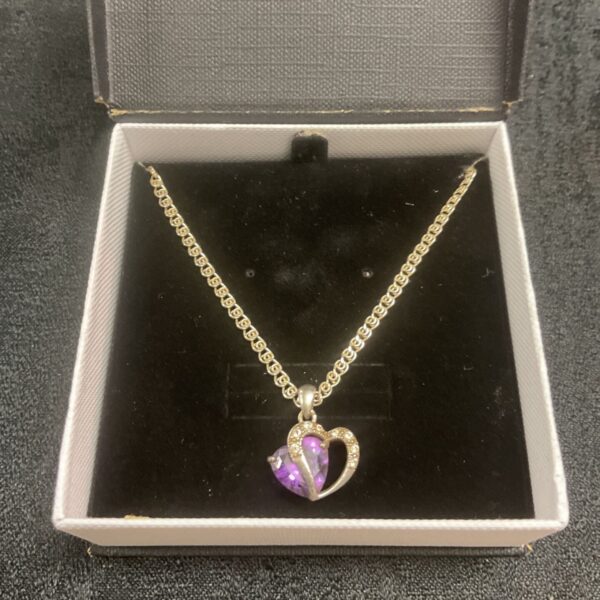 Silver necklace with a heart-shaped amethyst pendant.