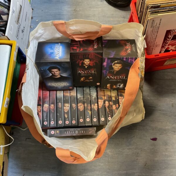 Collection of Angel DVD box sets in plastic wrapping.