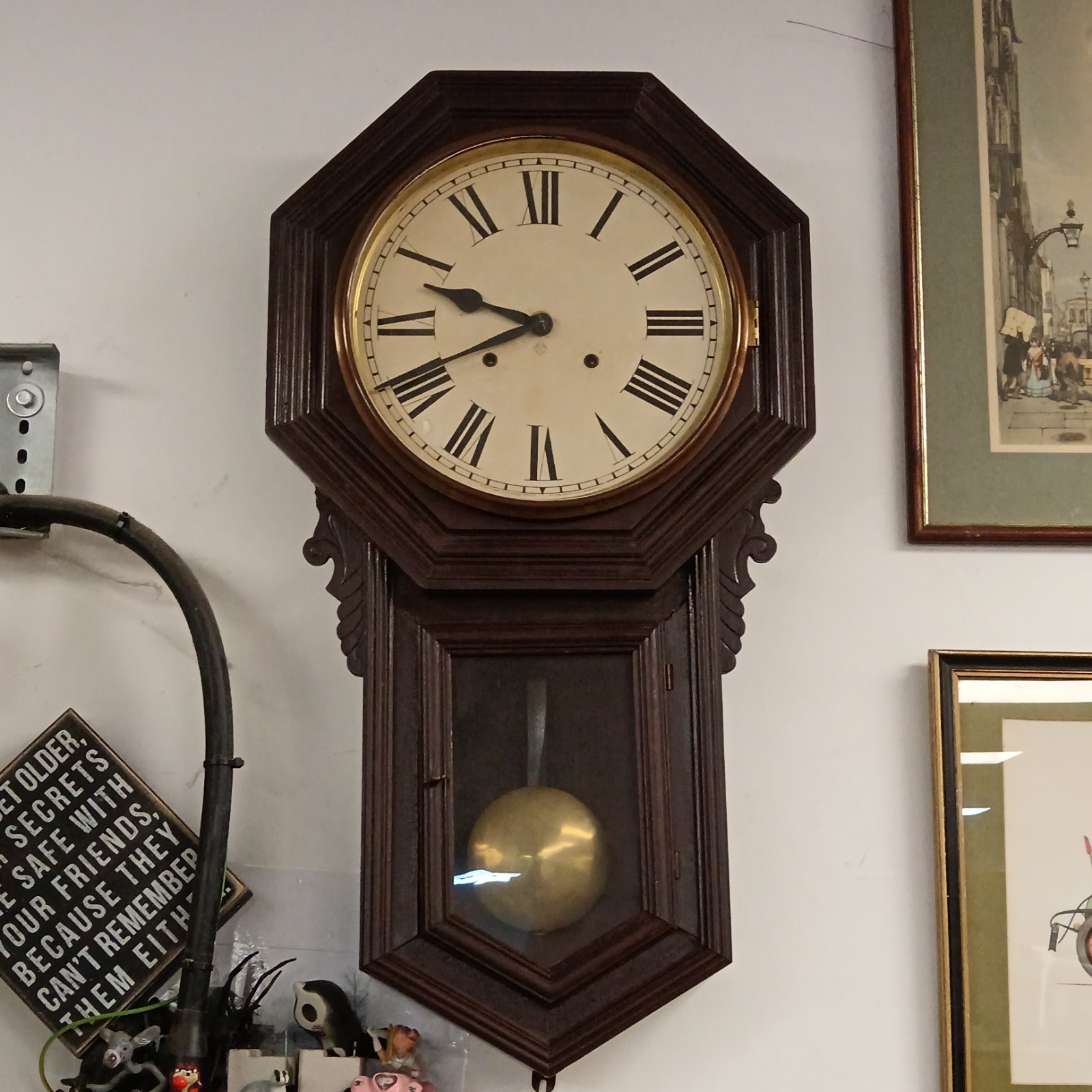Antique Ansonia schoolhouse wall clock with Roman numerals.