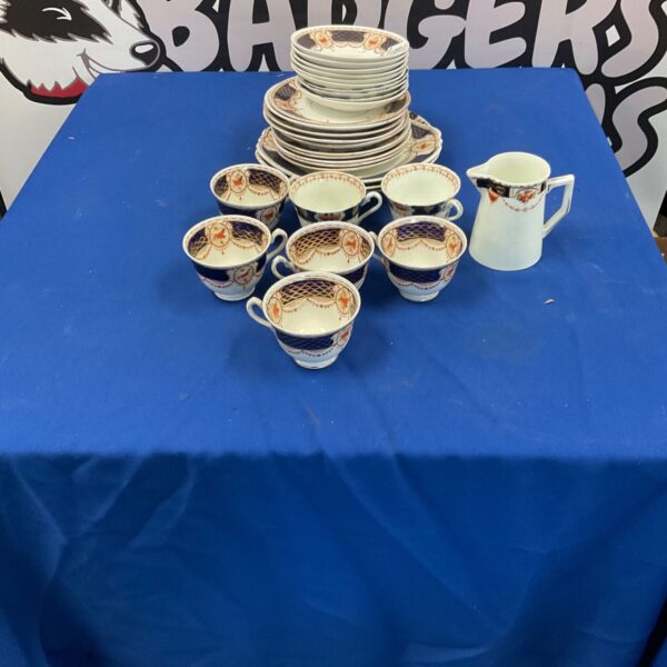 Antique court china collection with floral patterned tea cups and plates.