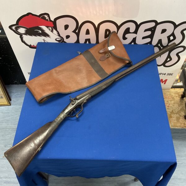 Antique deactivated double barrel shotgun on a blue background.