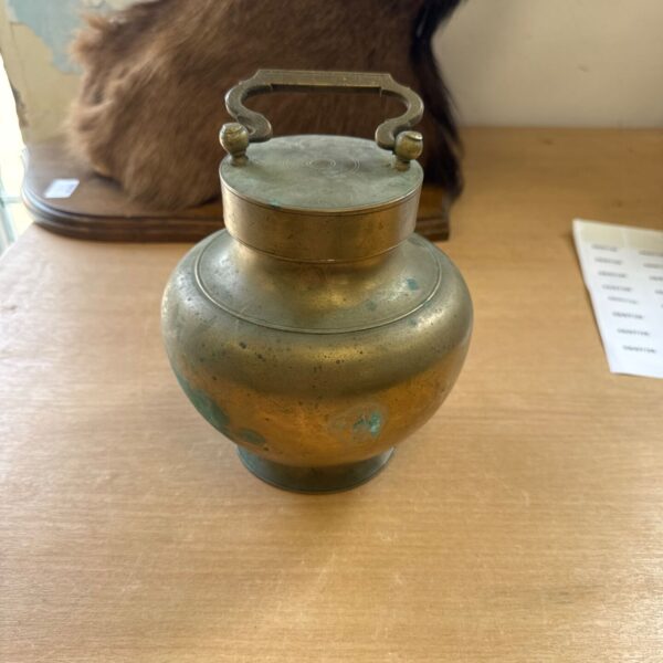Antique Indian brass water vessel with handle and patina.